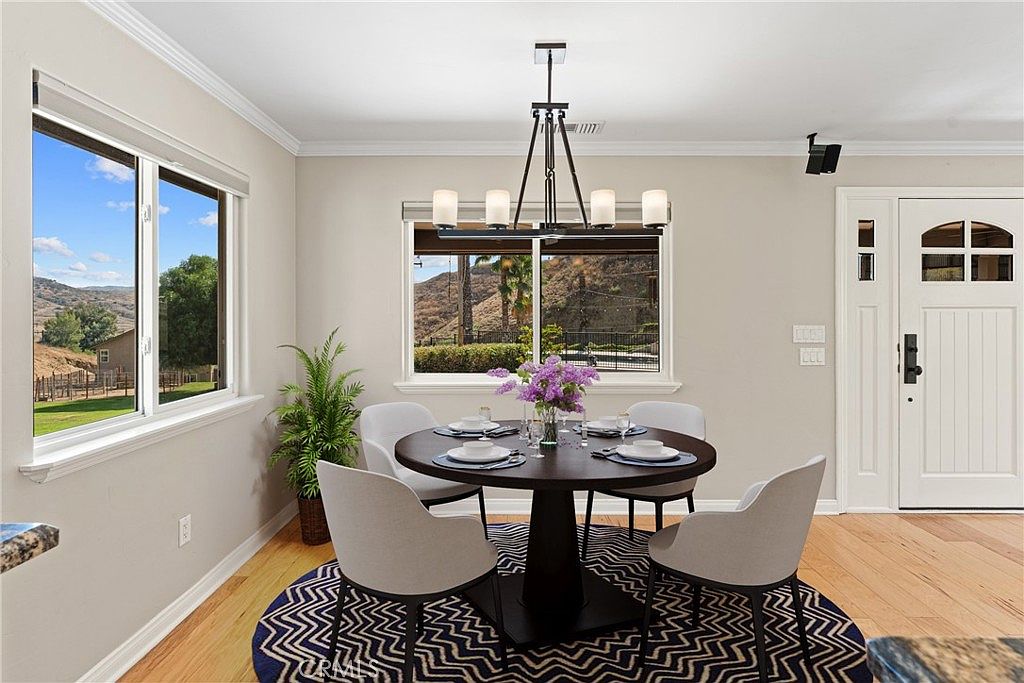 Dining area with canyon view through a large window, breakfast nook and chandelier
